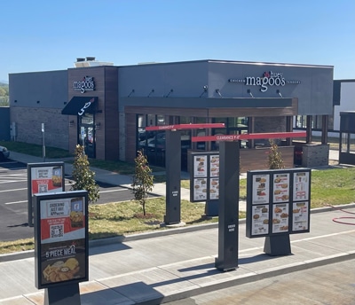 Exterior of a Huey Magoo’s drive-thru restaurant with drive lane visible during the day