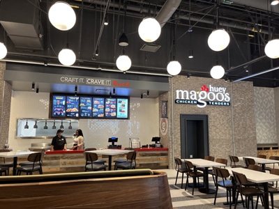 Interior view of a Huey Magoo’s restaurant with ordering counter and staff behind it