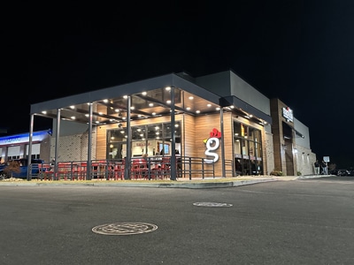 Huey Magoo’s restaurant location at night with building lights illuminated