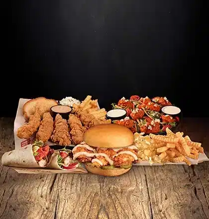 Assortment of Huey Magoo’s menu items including chicken tenders, signature dipping sauces, and sides, showcasing the brand’s handcrafted tenderloin chicken and franchise dining experience.
